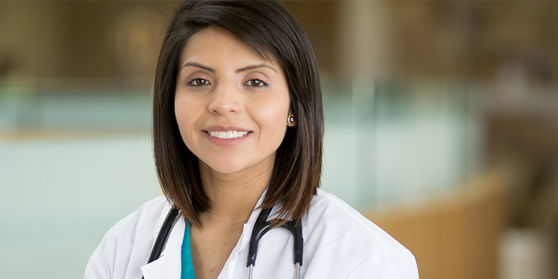 Portrait of an attractive young female physician. Image contains copy space and bokeh.